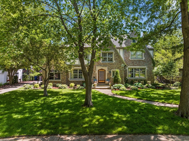 english style home with a front yard