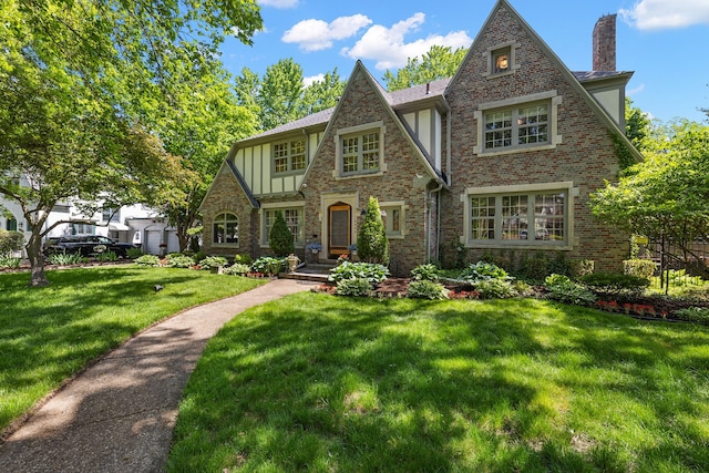 english style home with a front lawn