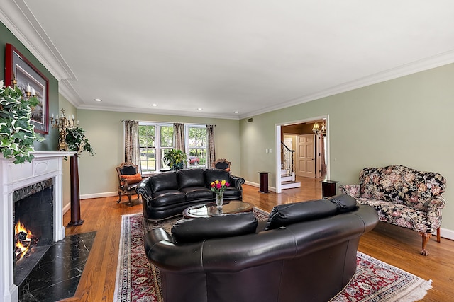 living room with a fireplace, crown molding, and hardwood / wood-style floors