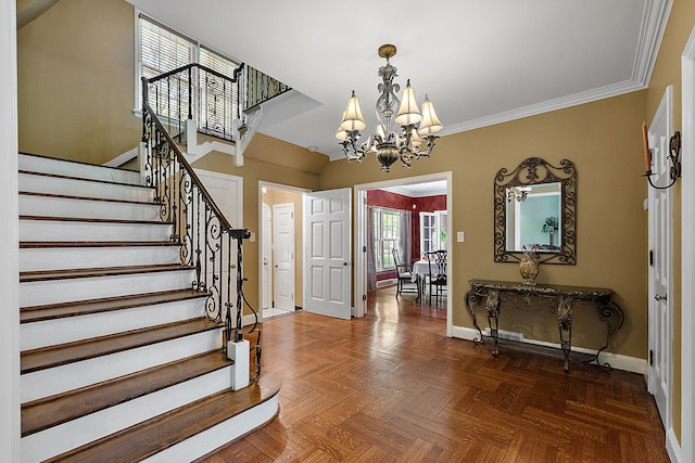 foyer entrance with dark parquet flooring, crown molding, and a notable chandelier