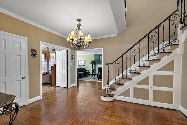 entrance foyer featuring a chandelier, parquet floors, and crown molding