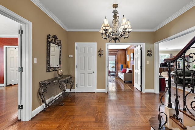 foyer featuring an inviting chandelier, a healthy amount of sunlight, and ornamental molding