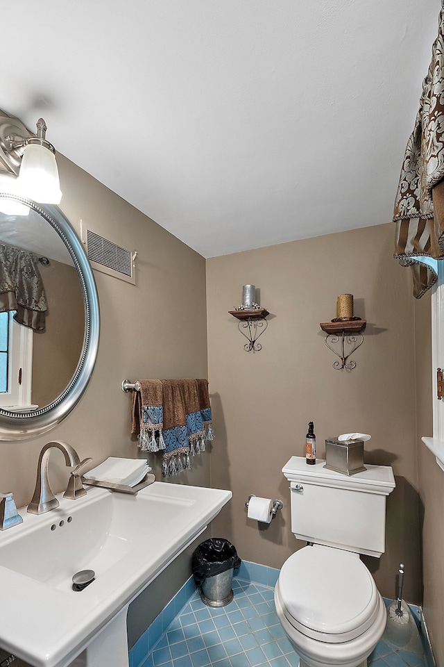 bathroom with tile patterned floors, sink, and toilet