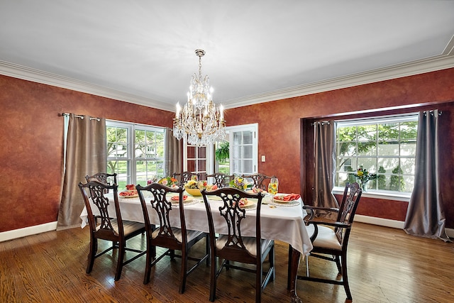 dining room featuring a chandelier, ornamental molding, and hardwood / wood-style flooring