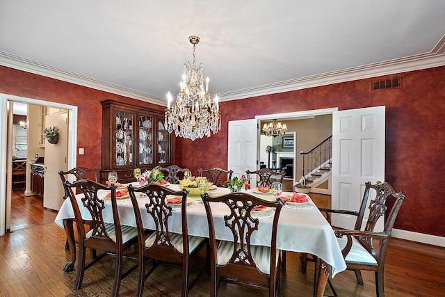 dining space featuring crown molding and wood-type flooring