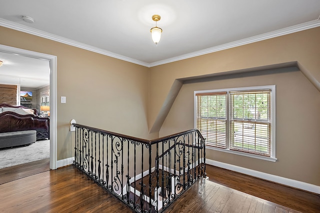 stairway featuring hardwood / wood-style floors and ornamental molding