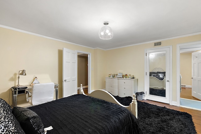 bedroom featuring hardwood / wood-style floors and crown molding