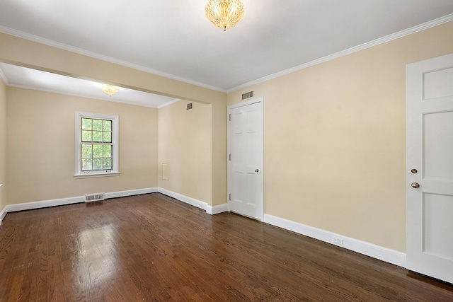 unfurnished room with ornamental molding and dark wood-type flooring