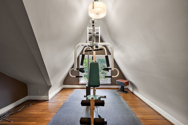 workout room featuring hardwood / wood-style flooring and lofted ceiling