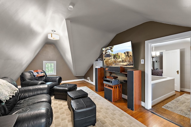 living room with hardwood / wood-style flooring and lofted ceiling