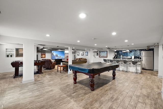 playroom featuring bar, light wood-type flooring, and pool table