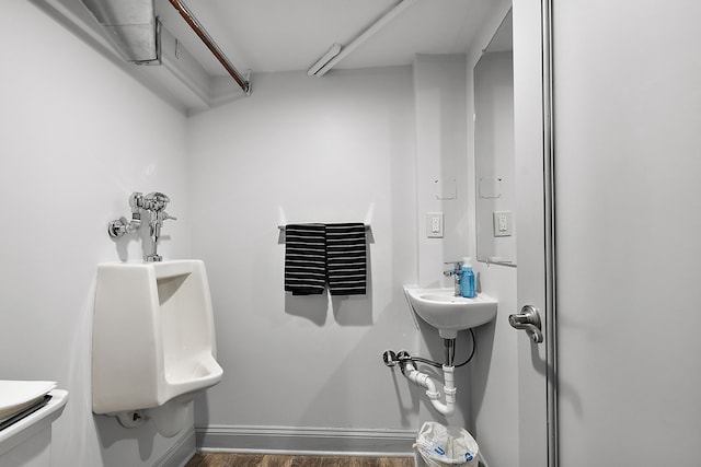 bathroom featuring hardwood / wood-style flooring and toilet