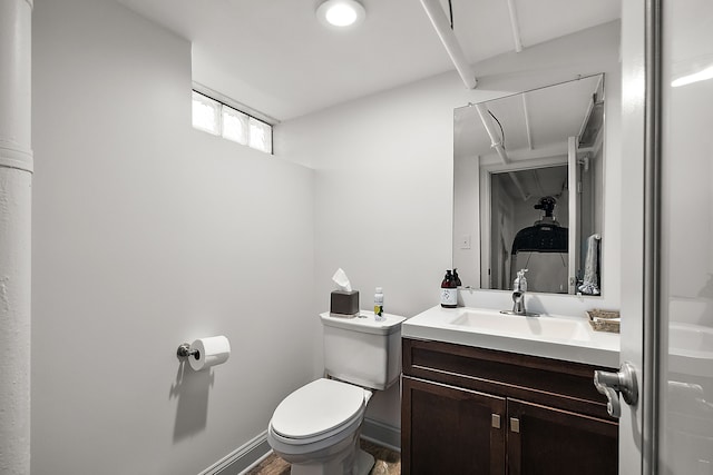 bathroom featuring hardwood / wood-style flooring, vanity, and toilet