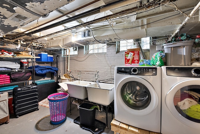 washroom with independent washer and dryer and sink