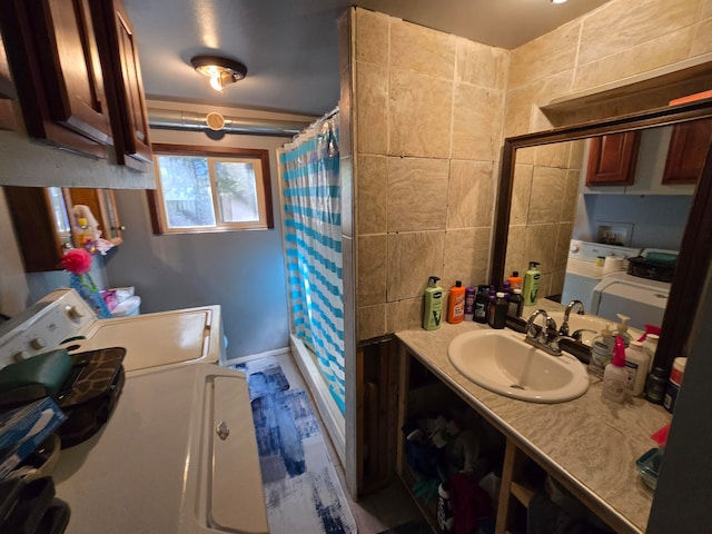 bathroom featuring a shower with shower curtain, vanity, and tile walls