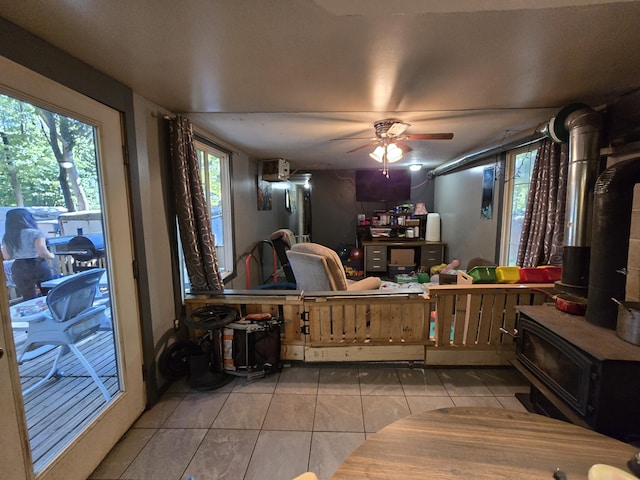 7867 W Wisconsin St, Shelby, MI 49455 - tiled living room featuring a wood stove and a ceiling fan