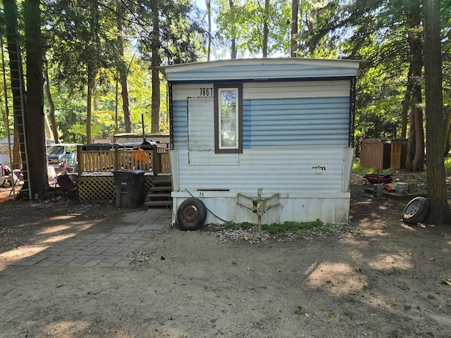 7867 W Wisconsin St, Shelby, MI 49455 - view of side of property featuring a wooden deck