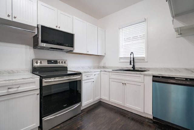 kitchen featuring sink, white cabinets, dark wood-type flooring, and appliances with stainless steel finishes