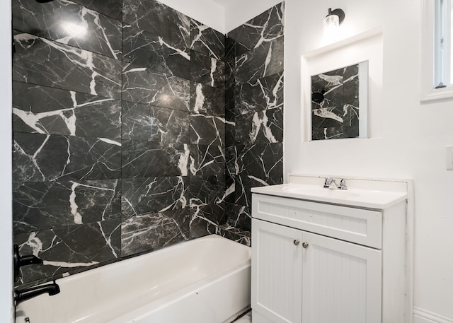 bathroom with vanity, shower / bath combination, and tile walls