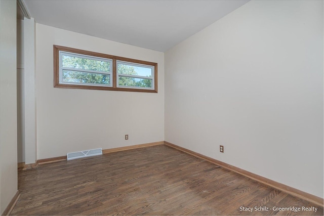 spare room with dark hardwood / wood-style floors