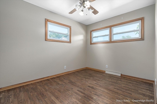 empty room with ceiling fan and dark wood-type flooring