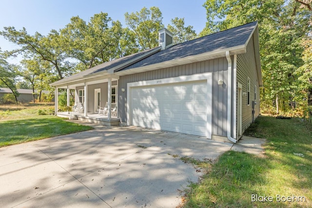 8981 Spruce Ave Unit B, Newaygo, MI 49337 - view of front of house featuring a garage, covered porch, concrete driveway, a chimney, and a front yard