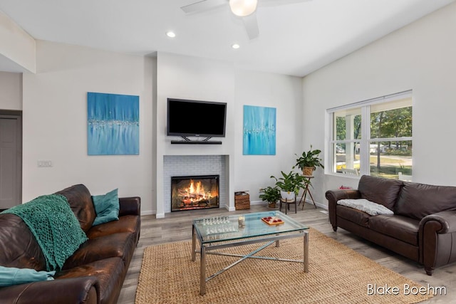 8981 Spruce Ave Unit B, Newaygo, MI 49337 - living room with wood finished floors, ceiling fan, a fireplace, recessed lighting, and baseboards