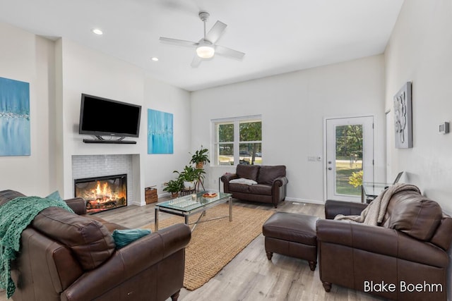 8981 Spruce Ave Unit B, Newaygo, MI 49337 - living room with light wood-style flooring, a ceiling fan, a tiled fireplace, and recessed lighting