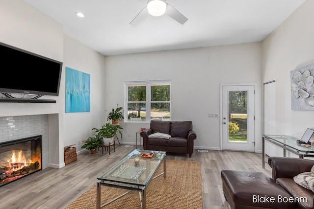 8981 Spruce Ave Unit B, Newaygo, MI 49337 - living room with a fireplace, ceiling fan, wood finished floors, baseboards, and recessed lighting