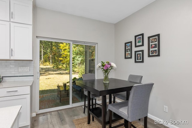 8981 Spruce Ave Unit B, Newaygo, MI 49337 - dining room featuring light wood-type flooring and baseboards