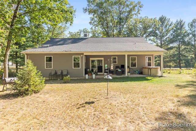8981 Spruce Ave Unit B, Newaygo, MI 49337 - back of property with a hot tub, a patio, a yard, an outdoor hangout area, and a shingled roof