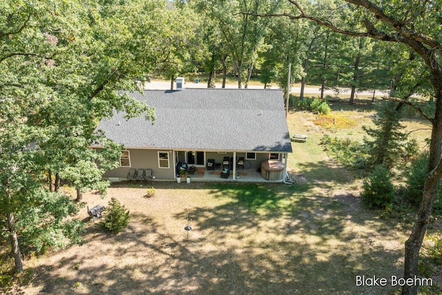 8981 Spruce Ave Unit B, Newaygo, MI 49337 - back of property with a patio area and a shingled roof
