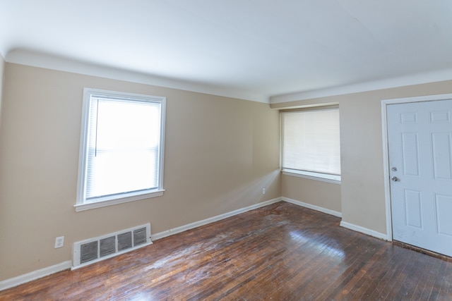 unfurnished room with dark hardwood / wood-style flooring