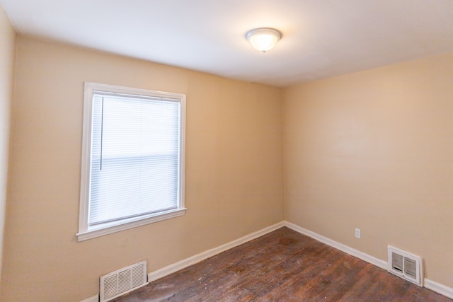 spare room featuring dark hardwood / wood-style flooring