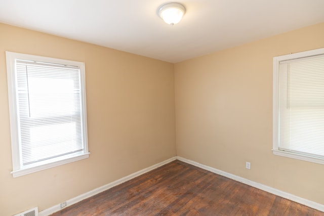 empty room with dark wood-type flooring