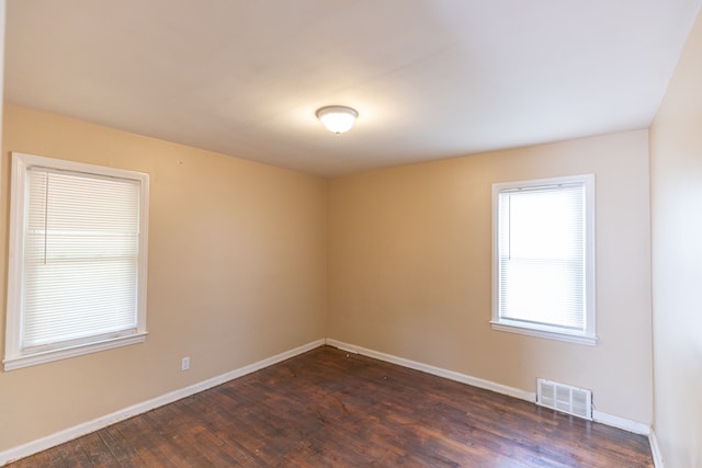 unfurnished room featuring dark wood-type flooring