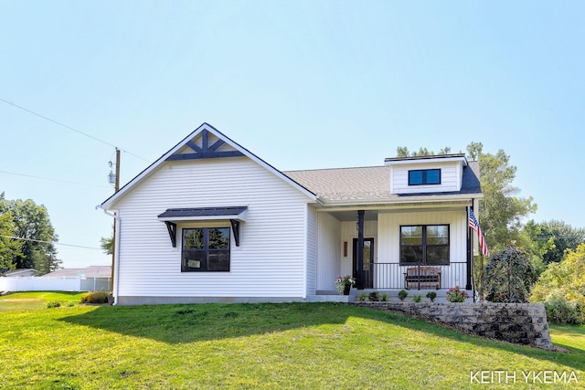 view of front of house with covered porch and a front lawn