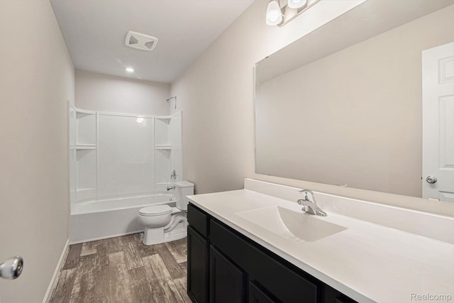 4442 Sprauge Ln, Swartz Creek, MI 48473 - bathroom with toilet, wood finished floors, vanity, bathtub / shower combination, and baseboards