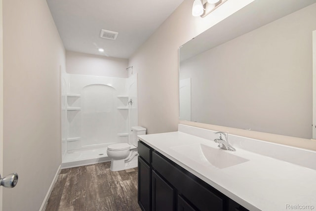 4442 Sprauge Ln, Swartz Creek, MI 48473 - full bathroom featuring toilet, vanity, a shower, wood finished floors, and baseboards