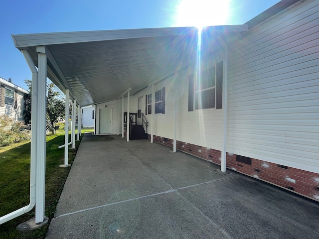 view of car parking featuring a carport and a yard