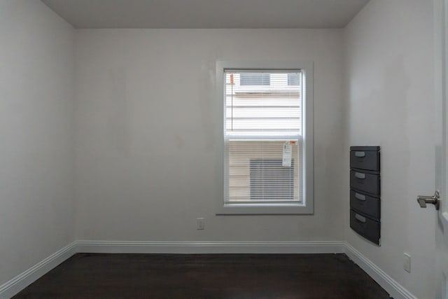 unfurnished room featuring dark hardwood / wood-style flooring