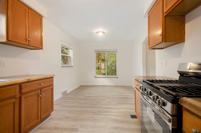 kitchen with gas stove and light hardwood / wood-style floors