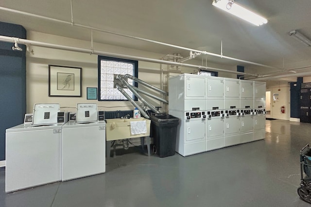 clothes washing area featuring washing machine and clothes dryer, stacked washer / dryer, and sink