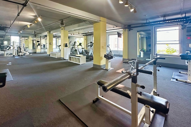 workout area featuring track lighting