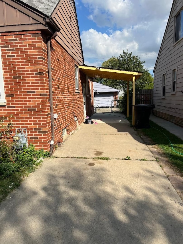 view of side of home with a carport