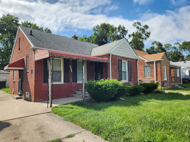 bungalow-style house featuring a front yard