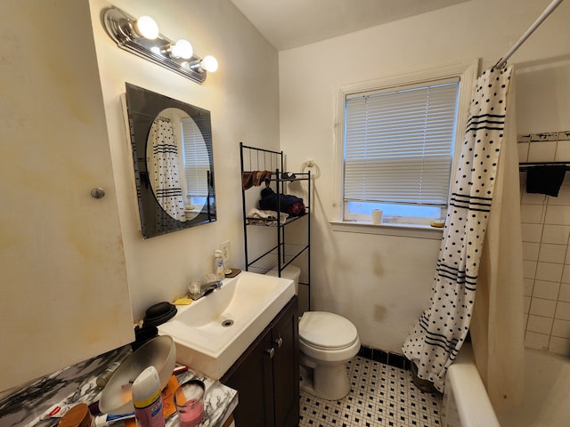 full bathroom with tile patterned floors, vanity, toilet, and shower / tub combo with curtain