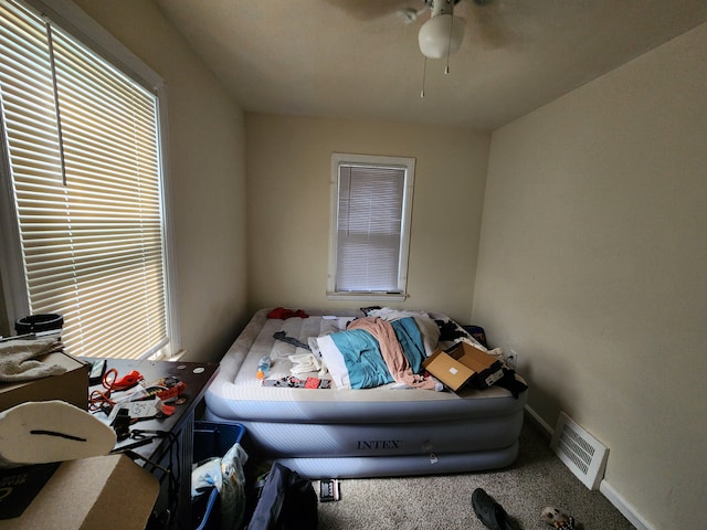 carpeted bedroom with ceiling fan