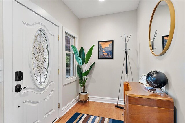 entrance foyer with light wood finished floors and baseboards