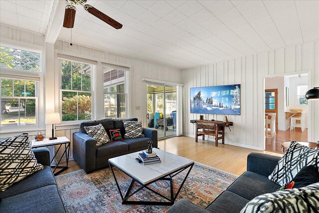 living room with light wood-type flooring and a ceiling fan